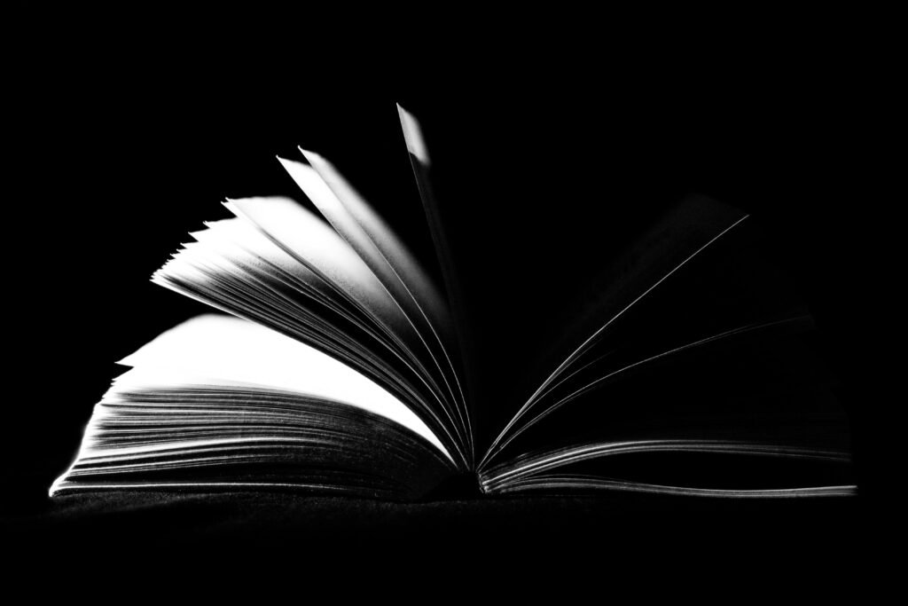 book-open-pages-literature-159872-159872 A striking black and white image of an open book with pages fanned out against a dark background.
